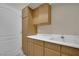 Functional utility sink with ample cabinet storage and white countertop at 8945 S Tenaya Way, Las Vegas, NV 89113