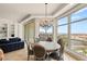 Elegant dining room with chandelier, large windows, and stunning city view, adjacent to the living room at 9101 Alta Dr # 706, Las Vegas, NV 89145