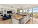Bright, open kitchen with granite countertops, stainless steel appliances, and access to a living area with floor to ceiling windows at 9101 Alta Dr # 706, Las Vegas, NV 89145