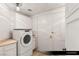 Bright laundry room with full-sized washer and dryer and built-in cabinets at 9101 Alta Dr # 706, Las Vegas, NV 89145