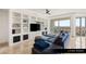 Comfortable living room features custom built-ins, sleek ceiling fan, and a large balcony at 9101 Alta Dr # 706, Las Vegas, NV 89145