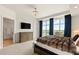 Inviting main bedroom featuring large windows, plush bedding, and stylish decor with an ensuite bathroom at 9101 Alta Dr # 706, Las Vegas, NV 89145