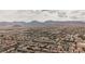Vast aerial perspective of a residential area nestled against a backdrop of majestic mountains at 9373 Oxbow Lake Ave, Las Vegas, NV 89149