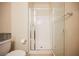 White shower with glass door and white tiled walls, offers a clean and functional space at 9373 Oxbow Lake Ave, Las Vegas, NV 89149