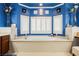 Bright bathroom showcasing a large tub with white tile, vanity, and shuttered windows for natural light at 9373 Oxbow Lake Ave, Las Vegas, NV 89149