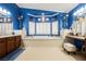 Bright bathroom showcasing a large tub with white tile, vanity, and shuttered windows for natural light at 9373 Oxbow Lake Ave, Las Vegas, NV 89149