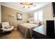 Serene bedroom with neutral tones, cozy chair, and a comfortable bed near a window with shutters at 9373 Oxbow Lake Ave, Las Vegas, NV 89149