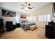 Bedroom featuring vaulted ceiling, a ceiling fan, large art, and plantation shutters at 9373 Oxbow Lake Ave, Las Vegas, NV 89149
