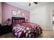 Comfortable bedroom features framed art, a ceiling fan, and a view to the hallway at 9373 Oxbow Lake Ave, Las Vegas, NV 89149