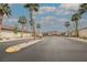 Elegant gated community entrance with palm trees lining a smooth, paved road at 9373 Oxbow Lake Ave, Las Vegas, NV 89149