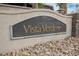 Close-up of the Vista Verde community sign set amidst decorative rocks and small cacti at 9373 Oxbow Lake Ave, Las Vegas, NV 89149