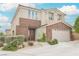 Beautiful two-story home with a two car garage, lush front yard, and brick accents at 9373 Oxbow Lake Ave, Las Vegas, NV 89149