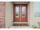Elegant double front doors with glass panels and a welcoming entrance mat at 9373 Oxbow Lake Ave, Las Vegas, NV 89149
