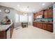 Bright kitchen with wood cabinets, granite counters, tile backsplash, stainless steel appliances, and a cozy breakfast nook at 9373 Oxbow Lake Ave, Las Vegas, NV 89149