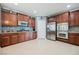 Well-equipped kitchen with stainless steel appliances, wood cabinetry, tile backsplash, and access to the pantry at 9373 Oxbow Lake Ave, Las Vegas, NV 89149