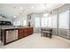 Kitchen area with stainless steel dishwasher, granite counters, and a breakfast nook with natural light at 9373 Oxbow Lake Ave, Las Vegas, NV 89149