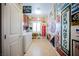 Unique laundry room with washer and dryer and walls decorated with vintage signs at 9373 Oxbow Lake Ave, Las Vegas, NV 89149