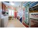 Well-lit laundry room showcasing vintage signs with washer, dryer, and storage cabinets at 9373 Oxbow Lake Ave, Las Vegas, NV 89149