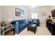 Comfortable living room with blue sofas and chair, complemented by decorative accents and soft lighting at 9373 Oxbow Lake Ave, Las Vegas, NV 89149