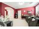 Living room, with a gray sofa, dark-colored chairs, and bright light from white shutters at 9373 Oxbow Lake Ave, Las Vegas, NV 89149
