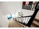 Carpeted staircase and railings, overlooking neutral walls and a visible chandelier at 9373 Oxbow Lake Ave, Las Vegas, NV 89149