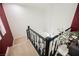 Carpeted staircase with black and white railings ascending to the second story at 9373 Oxbow Lake Ave, Las Vegas, NV 89149