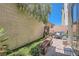 Private backyard featuring a brick paver patio, green plants, artificial turf, and a bench at 939 Paisley St, Las Vegas, NV 89145