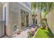 Beautiful backyard with brick pavers, lush plants, stucco walls, a grill and an outdoor seating area at 939 Paisley St, Las Vegas, NV 89145