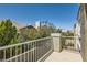 Exterior shot of a home balcony that overlooks trees, other homes, and blue skies at 939 Paisley St, Las Vegas, NV 89145