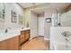 Well-lit bathroom with double sink vanity, soaking tub and separate glass enclosed shower at 939 Paisley St, Las Vegas, NV 89145