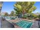 Community hot tub area with an outdoor table set, landscaping, and multiple hot tubs to use at 939 Paisley St, Las Vegas, NV 89145