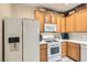 Efficient kitchen layout with white refrigerator and oven, plus ample cabinet storage space at 939 Paisley St, Las Vegas, NV 89145