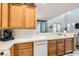 Bright kitchen showcasing white appliances, tile counters, and connection to an adjacent living space at 939 Paisley St, Las Vegas, NV 89145