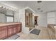 Well-appointed bathroom with walk-in shower, soaking tub, and neutral tile at 9504 Empire Rock St, Las Vegas, NV 89143