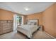 Comfortable bedroom with a window view, dresser, and mirror at 9504 Empire Rock St, Las Vegas, NV 89143