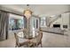 Dining area with glass table, chandelier, and view of the living room and backyard at 9504 Empire Rock St, Las Vegas, NV 89143