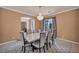 Elegant dining room featuring a chandelier, decorative rug, and large windows at 9504 Empire Rock St, Las Vegas, NV 89143