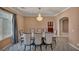 Formal dining room with elegant lighting fixture, large window, and seating for eight, perfect for entertaining at 9504 Empire Rock St, Las Vegas, NV 89143