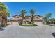 Two-story house with three-car garage, driveway, and symmetrical palm trees creating curb appeal at 9504 Empire Rock St, Las Vegas, NV 89143