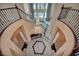 Staircase with chandelier and beautiful tiled floors in the foyer, offering a grand entrance to the residence at 9504 Empire Rock St, Las Vegas, NV 89143