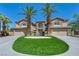 Beautiful two-story home featuring a circular driveway and two majestic palm trees framing the entrance at 9504 Empire Rock St, Las Vegas, NV 89143