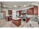 Spacious kitchen featuring stainless steel appliances, a large island, and beautiful cherry wood cabinets at 9504 Empire Rock St, Las Vegas, NV 89143