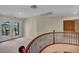 Second floor landing with carpet floors and access to a balcony showcasing a view of palm trees at 9504 Empire Rock St, Las Vegas, NV 89143