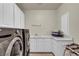 Functional laundry room with washer, dryer, sink, and ample counter space at 9504 Empire Rock St, Las Vegas, NV 89143