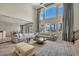 Bright and airy living room with soaring ceilings, large windows, and a comfortable sectional sofa at 9504 Empire Rock St, Las Vegas, NV 89143