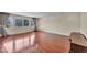 Large room with hardwood floors and natural light is streaming in from the windows and illuminating the space at 9504 Empire Rock St, Las Vegas, NV 89143