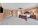 Spacious main bedroom with a ceiling fan, carpet, and an en-suite bathroom that invites relaxation at 9504 Empire Rock St, Las Vegas, NV 89143