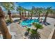 Backyard oasis with pool, waterfall, and lush landscaping, creating a private retreat at 9504 Empire Rock St, Las Vegas, NV 89143