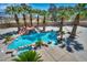 Gorgeous pool featuring a waterfall, mature palm trees, and lounge area at 9504 Empire Rock St, Las Vegas, NV 89143