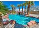 Beautiful pool with rock features and lush palm trees creating a relaxing atmosphere at 9504 Empire Rock St, Las Vegas, NV 89143